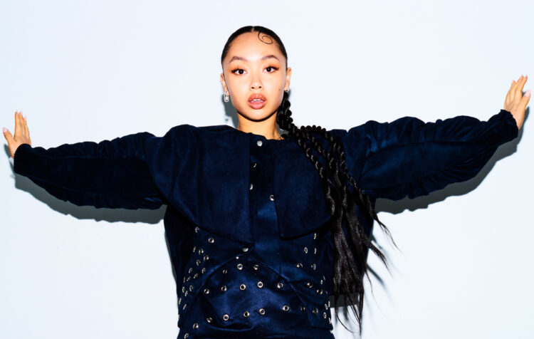 Musical artist Griff in a navy and black sweater, photographed by Bella Howard for NME