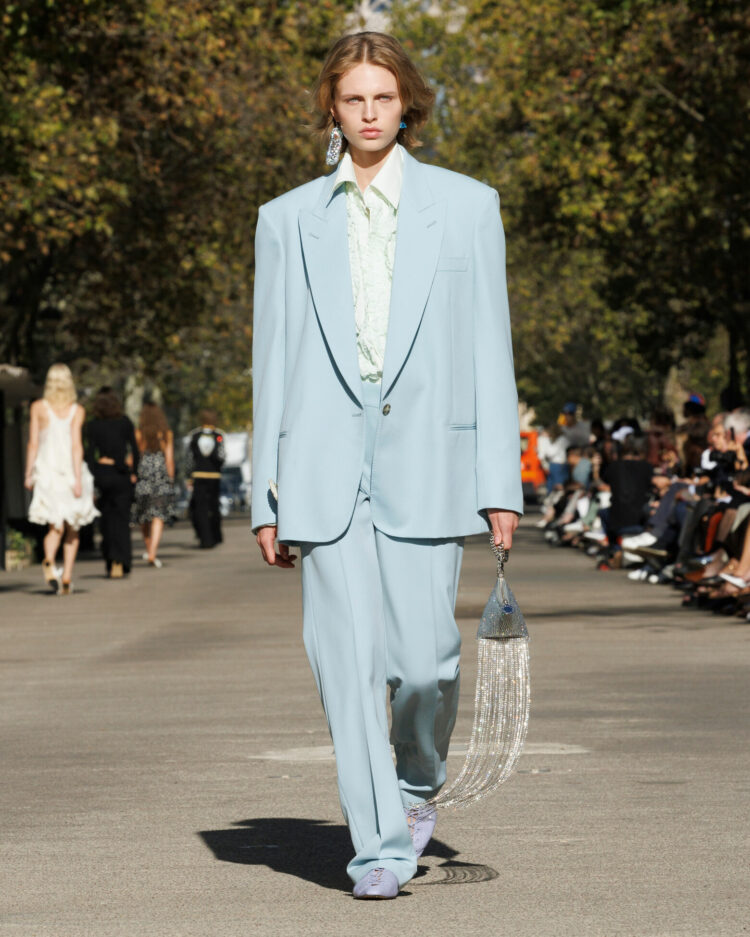 Ice blue oversized pantsuit over a very pale celadon shirt and blue suede shoes at Stella McCartney spring summer 2024 runway show
