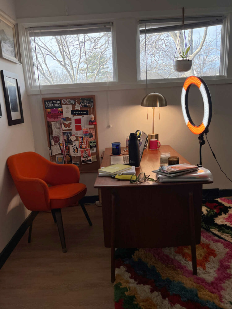 a large ring light in front of a mid century modern desk and orange chair set up for a Zoom