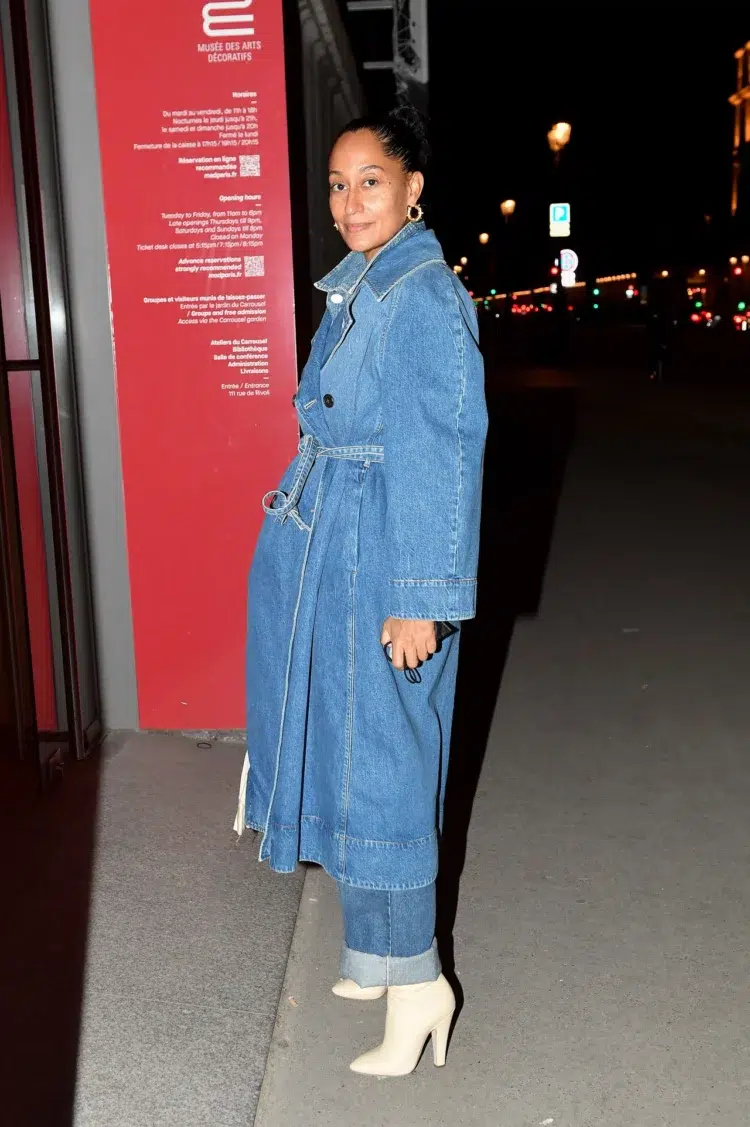 Actress Tracee Ellis Ross in a denim trench, cuffed relax fit jeans, and cream western-inspired heeled boots