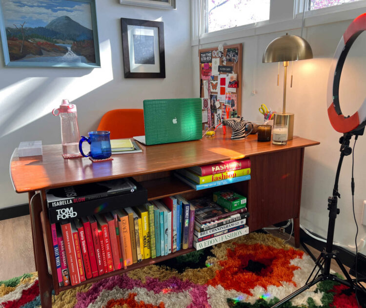 art and fashion books in the shelf of a vintage mid century modern desk