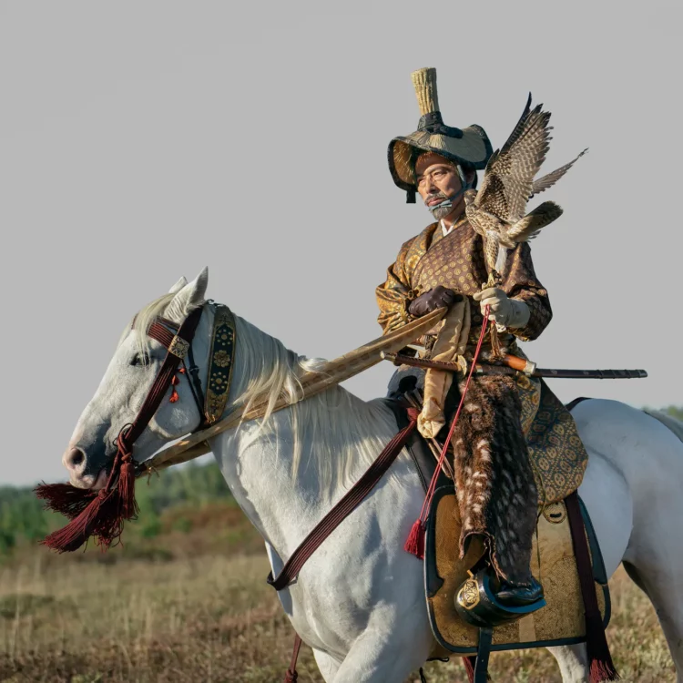 scene from the FX series Shogun with actor Hiroyuki Sanada in historical Japanese battle gear sitting on a white horse