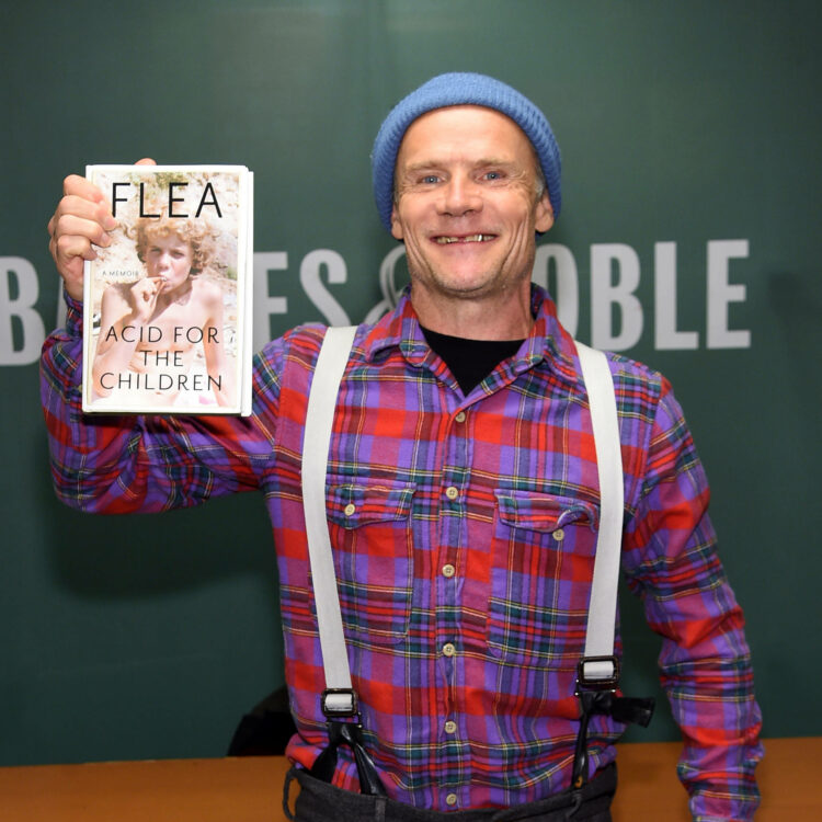 flea holding his book acid for the children