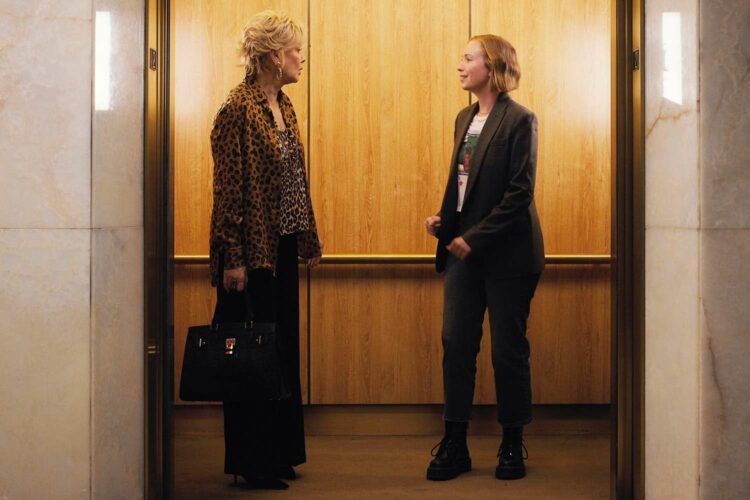 the characters Deborah and Ava from the TV show Hacks, looking at one another in an elevator