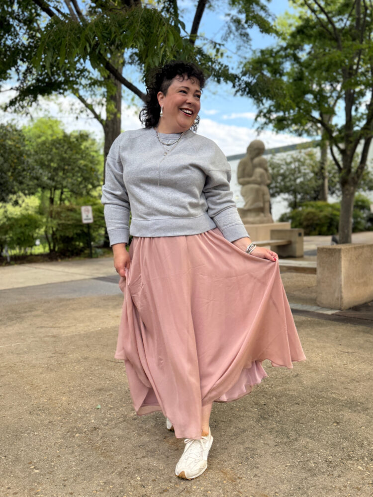 woman in a gray sweatshirt and long pink ballerina skirt from ann taylor