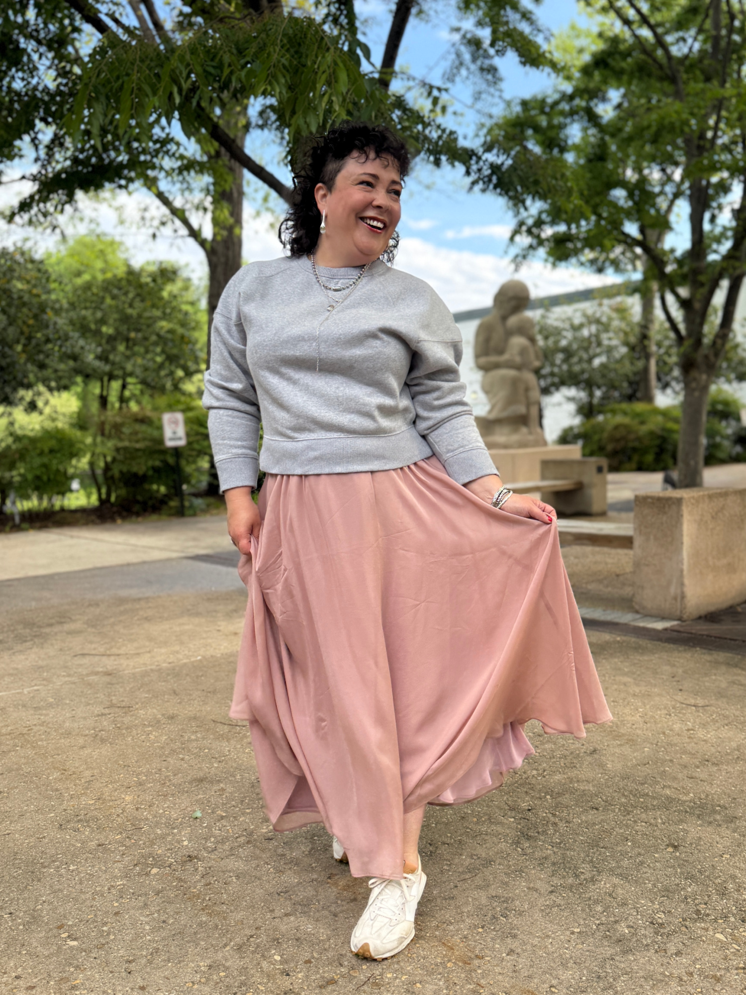 woman in a gray sweatshirt and long pink ballerina skirt from ann taylor