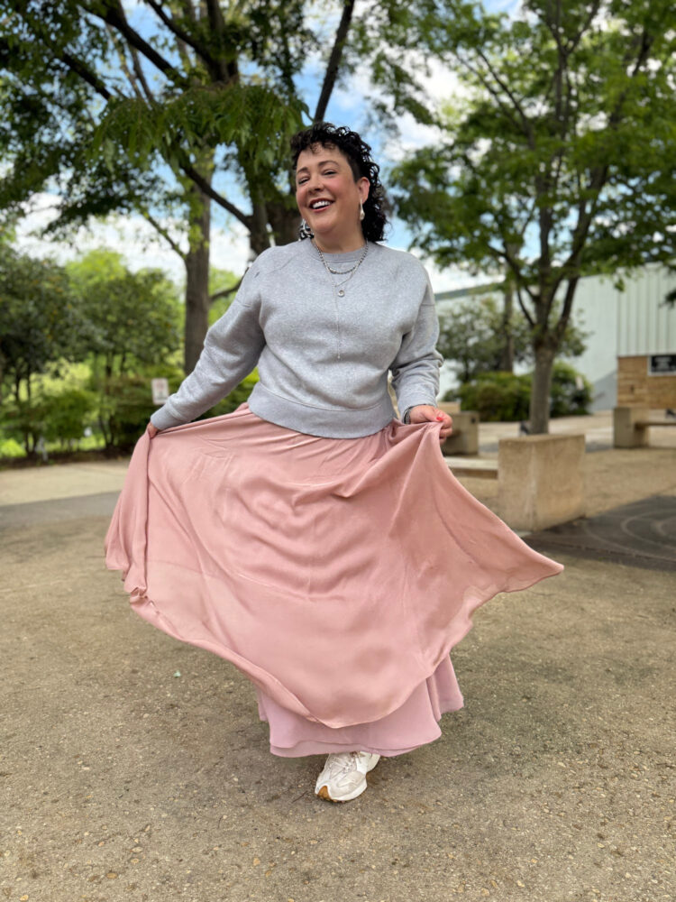 woman in a gray sweatshirt and long pink ballerina skirt from ann taylor