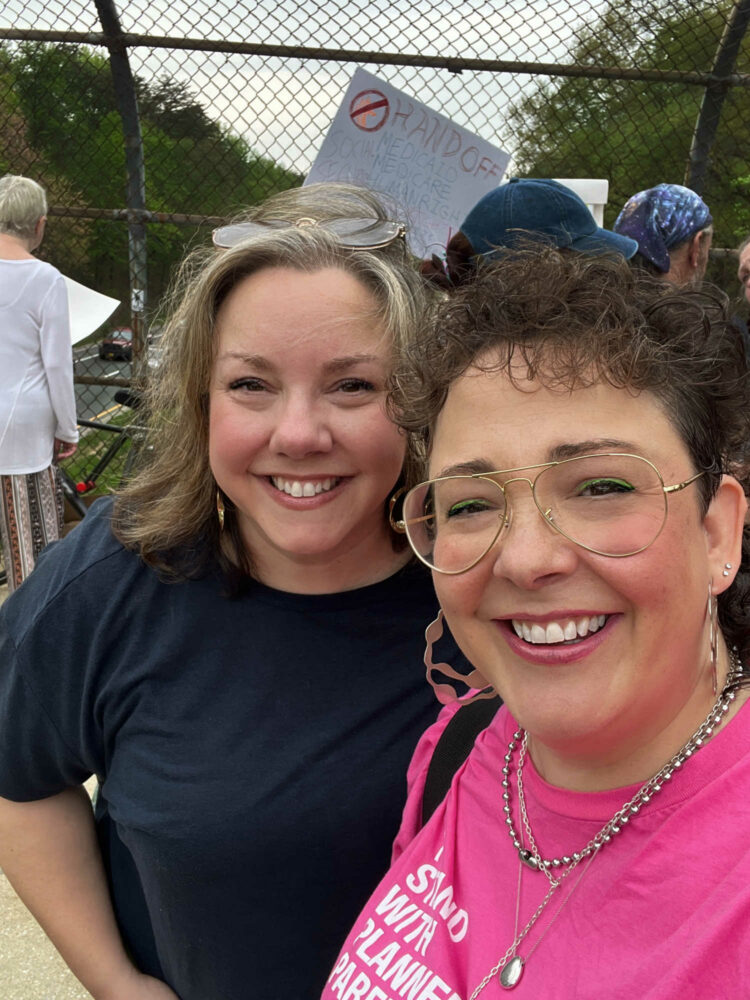 two women at the greenbelt spellman overpass protest april 2025