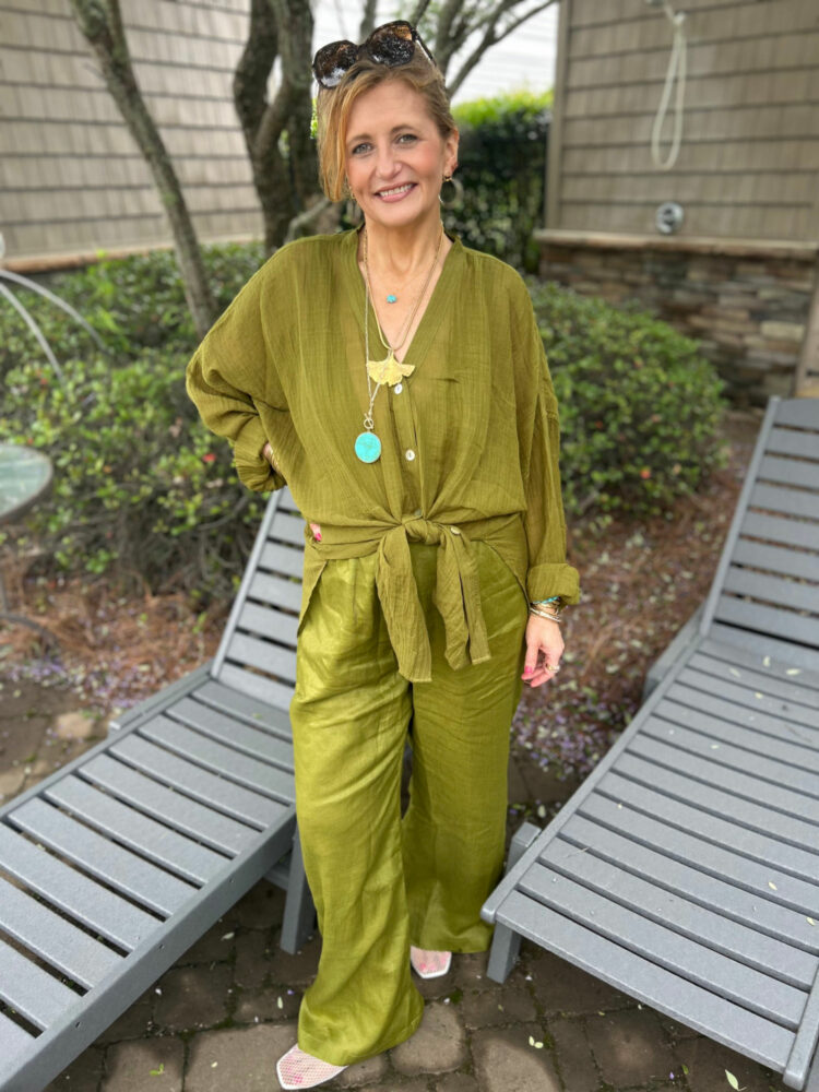 Woman in an olive green gauze shirt and matching pants from Monday Swimwear
