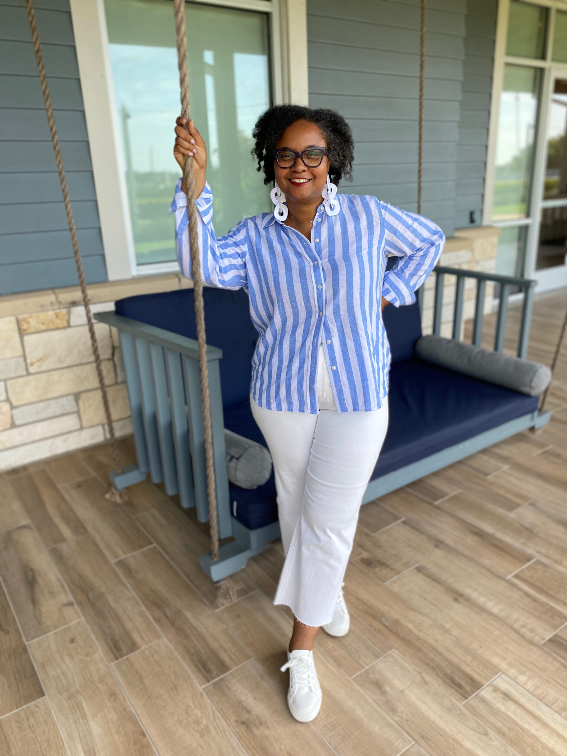 over 40 woman in a blue and white striped J. Crew Factory linen shirt paired with cropped wide leg jeans