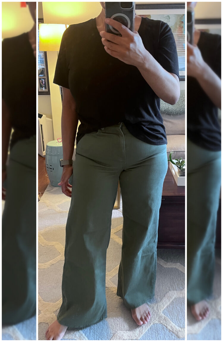 Woman trying on the Quince Bella Stretch Wide Leg Jeans in midsize 30 in loden green