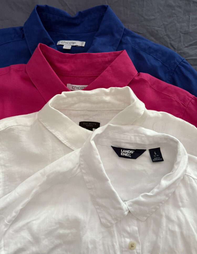 a stack of four linen button-front shirts for women