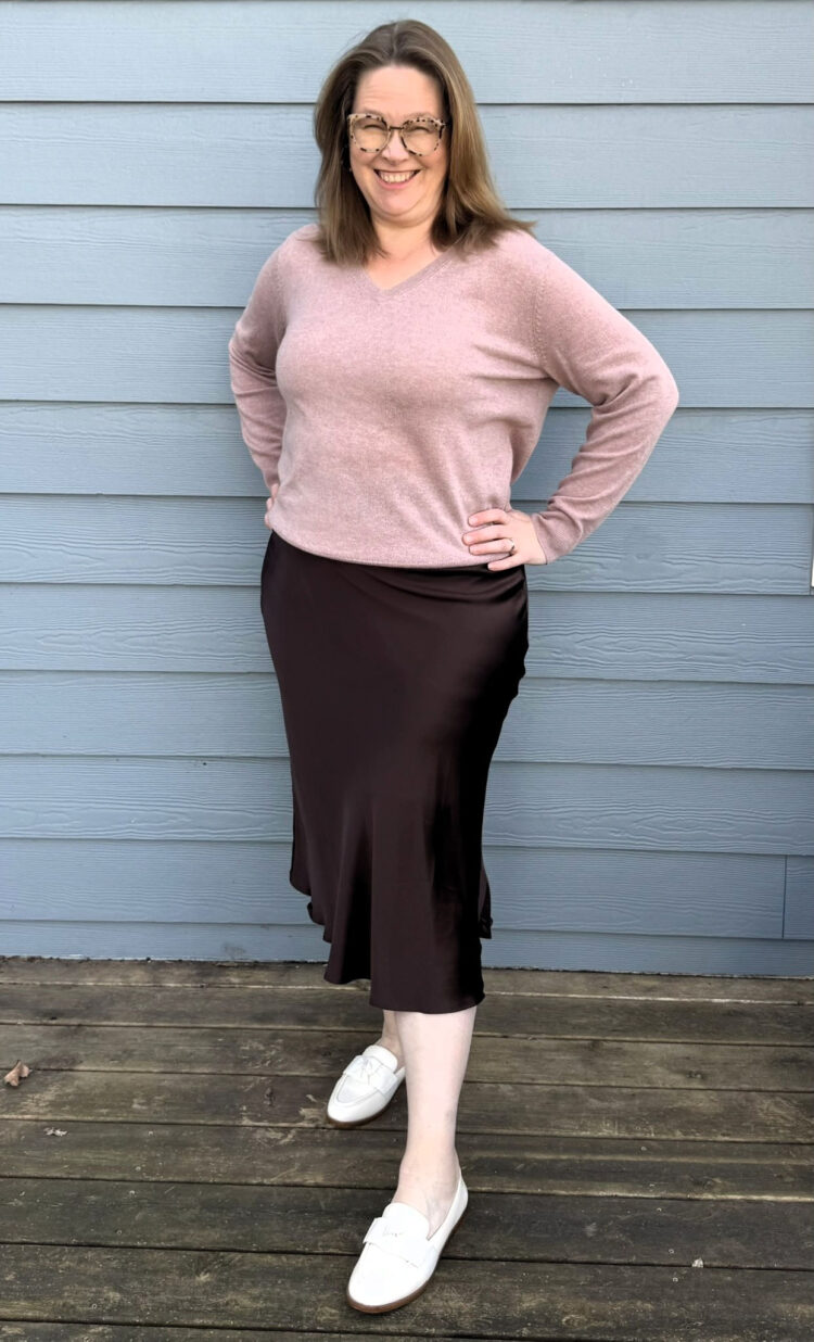 Quince Plus Size Clothing Review: An Honest Community Member Take 2 Tricia wearing the Quince Washable Silk Skirt in Hot Fudge with the Mongolian Cashmere V-Neck Sweater in Heather Vintage Pink and white loafers