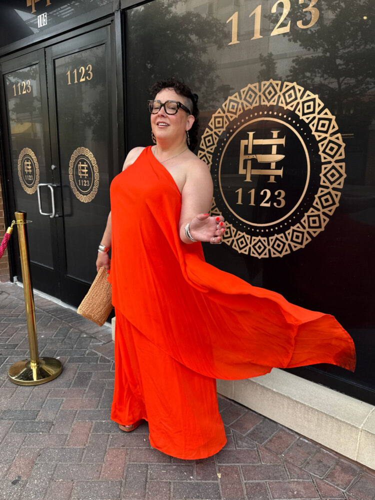 What I Wore to an Embassy Gala 4 alison gary of wardrobe oxygen in june 2025 standing outside a restaurant wearing an orange silk one shoulder gown