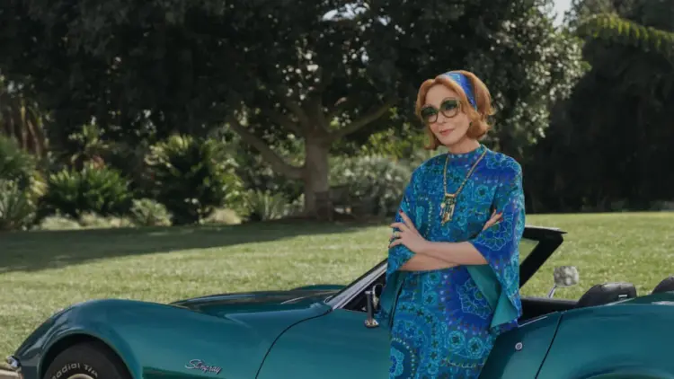 Weekend Reads for January 10 & 11 7 Allison Janney in Palm Royale wearing a caftan and leaning against a Stingray convertible