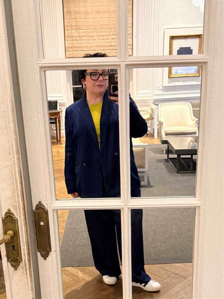 Valentine's Day Weekend Reads 2 alison gary of wardrobe oxygen at an indivisible event in 2026 wearing a navy satin pantsuit with a lime shell top