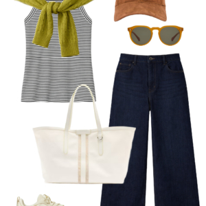 Spring 2026 petite and midsize capsule wardrobe outfit 23: striped tank, lime cable-knit sweater tied over shoulders, dark wide-leg jeans, cream tote, sneakers, baseball cap