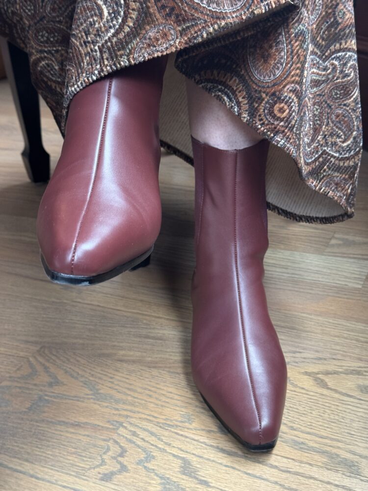 Quince Shoes Review: Italian Leather Boots, Loafers, and Flats Tested by a Real Woman in Her 50s 5 review of the quince ankle boots in merlot for wardrobe oxygen styled on an over 50 woman with a paisley corduroy midi length shirtdress