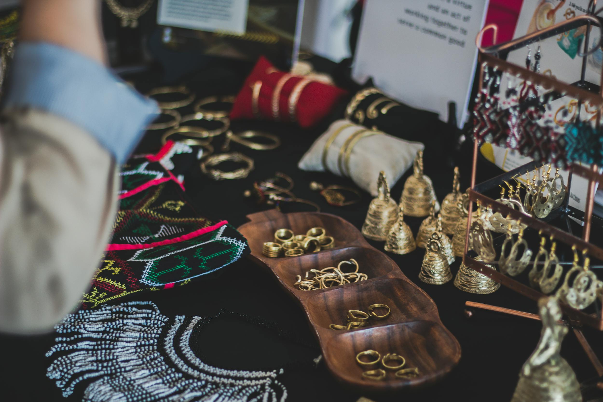 Close-up of a variety of elegant jewelry, including rings, earrings, and necklaces on display indoors.