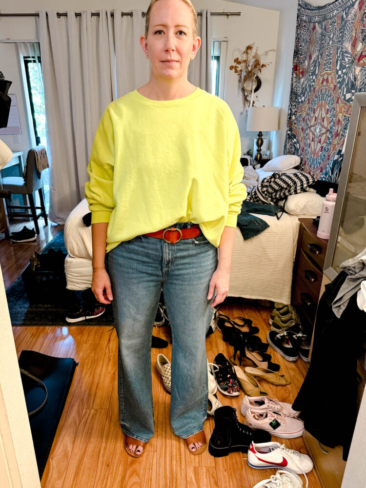 Personal Stylist Experience: One Woman's Honest Closet Edit Story 5 sharon wearing a chartreuse top creatively tucked into a pair of jeans styled with a red belt
