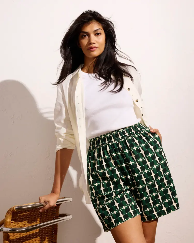 The Best Shorts for Grown-Ass Women: Styles for Most Every Body 11 Woman wearing the green trellis print of the Universal Standard Juniper Linen Easy Pull-On Shorts