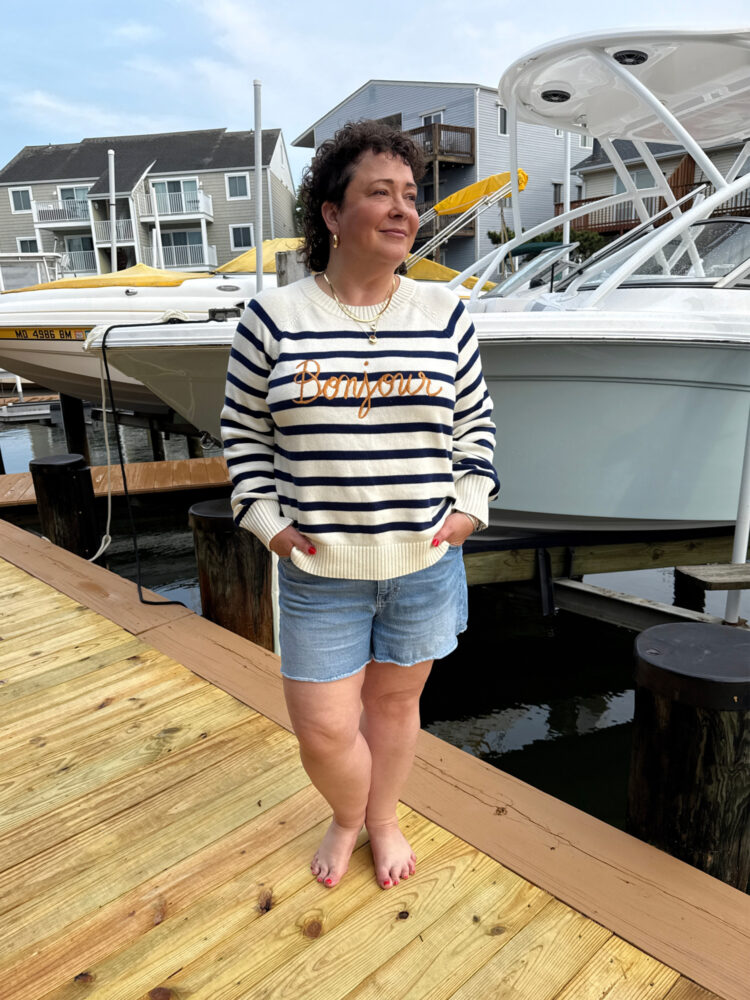alison gary of wardrobe oxygen in denim cutoff shorts and a Lands' End drifter sweater