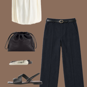 l12 White open-knit cotton-linen sweater tee and cream linen full-length pants with a silver-buckle leather belt, black leather tote, and cream leather sneakers