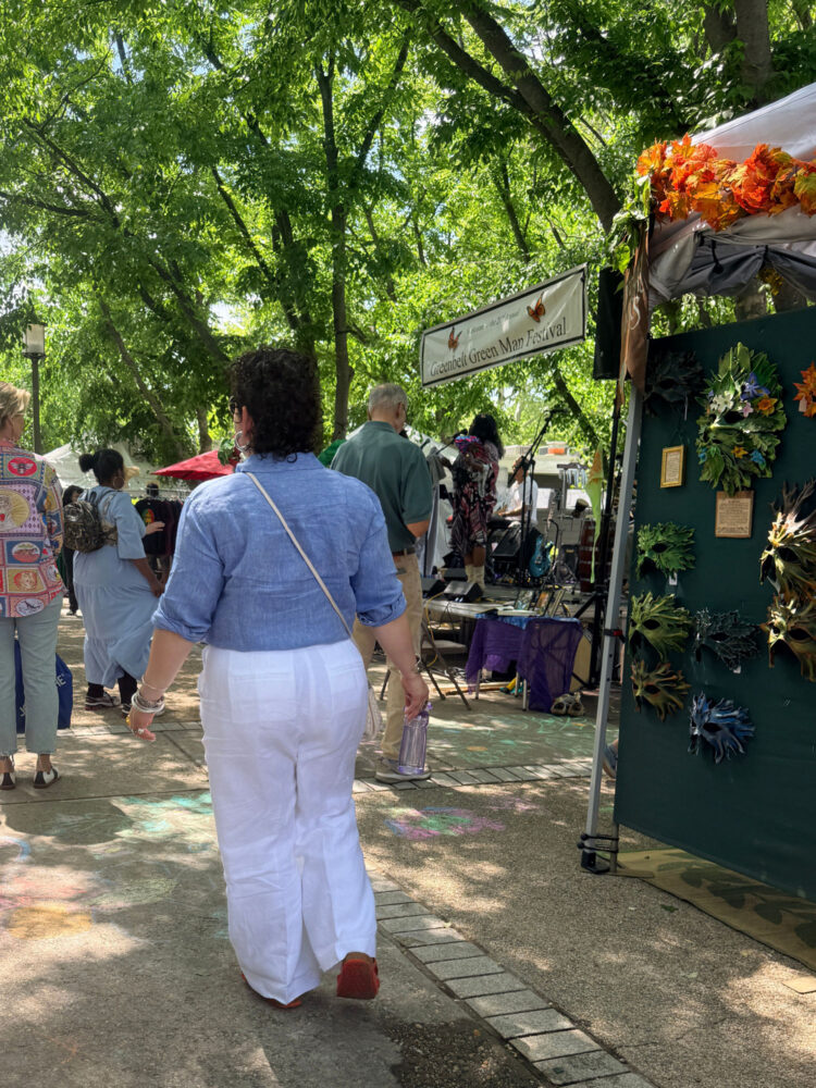 Talbots Linen Review (and how to save 30% on your purchase) 5 Back view of Alison Gary in white Talbots Wide Leg Linen Pants at an outdoor festival, showing the drape and silhouette of wide leg linen trousers.
