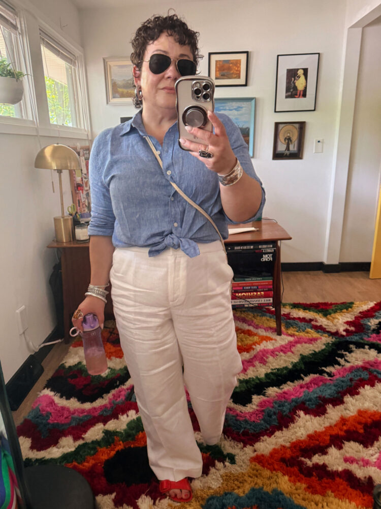 Alison Gary wearing the Talbots Linen Everyday Relaxed Shirt in cornflower blue cross dye tied at the waist with white Talbots Wide Leg Linen Pants, home mirror selfie showing full outfit with red sandals.
