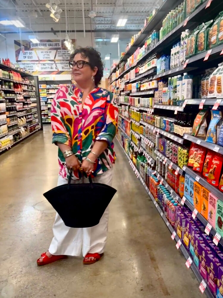 alison gary of wardrobe oxygen in a multicolored boden linen tunic with white spanx twill pants and a black cos tote