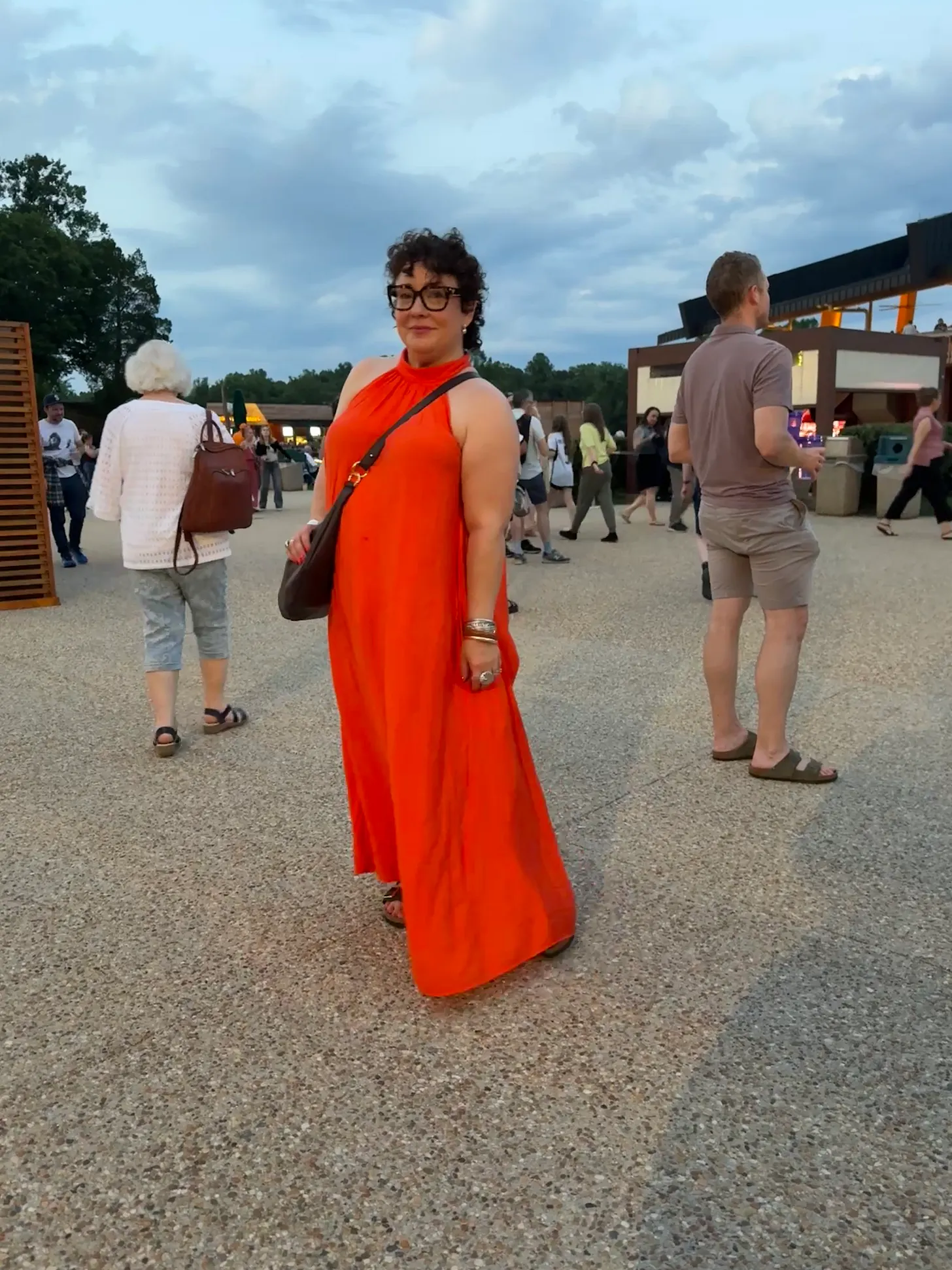 alison gary in an orange halter maxi dress from COS with a Hyer Goods ring bag in brown leather while at a Tori Amos concert at Wolf Trap