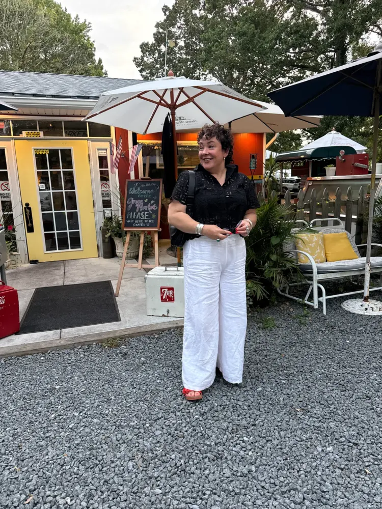 What I Wore Recently: July 2026 4 alison gary of wardrobe oxygen in ocean city wearing a black eyelet button-front shirt from M.M.LaFleur with Lands' End white linen palazzo pants