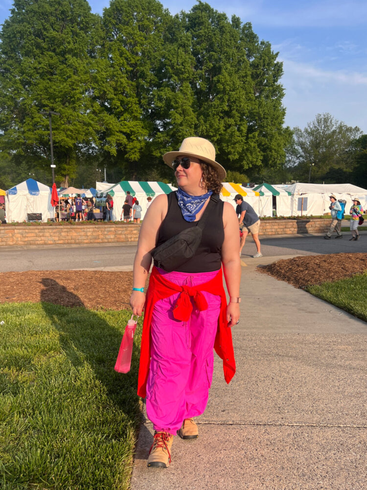 Woman in a black tank and pink parachute pants at the Merlefest music festival in North Carolina
